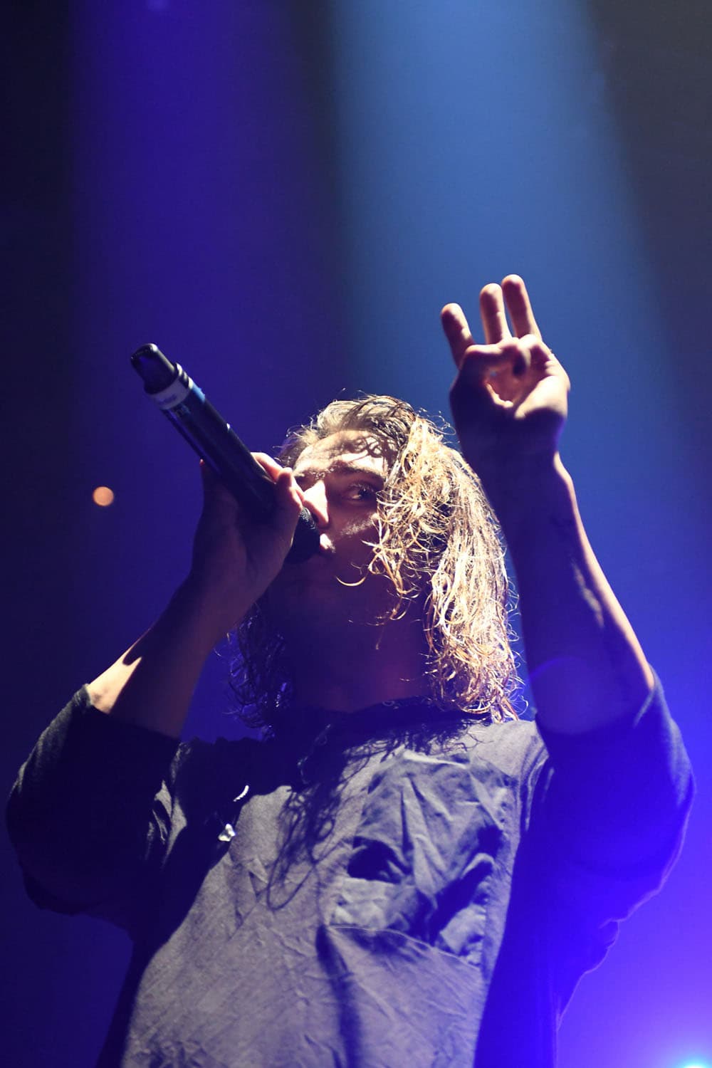 Concert photography of folk-pop artist Judah Akers from Judah & the Lion performing. Genre-blending musical performance with acoustic instrumentation and dynamic stage presence professionally captured.