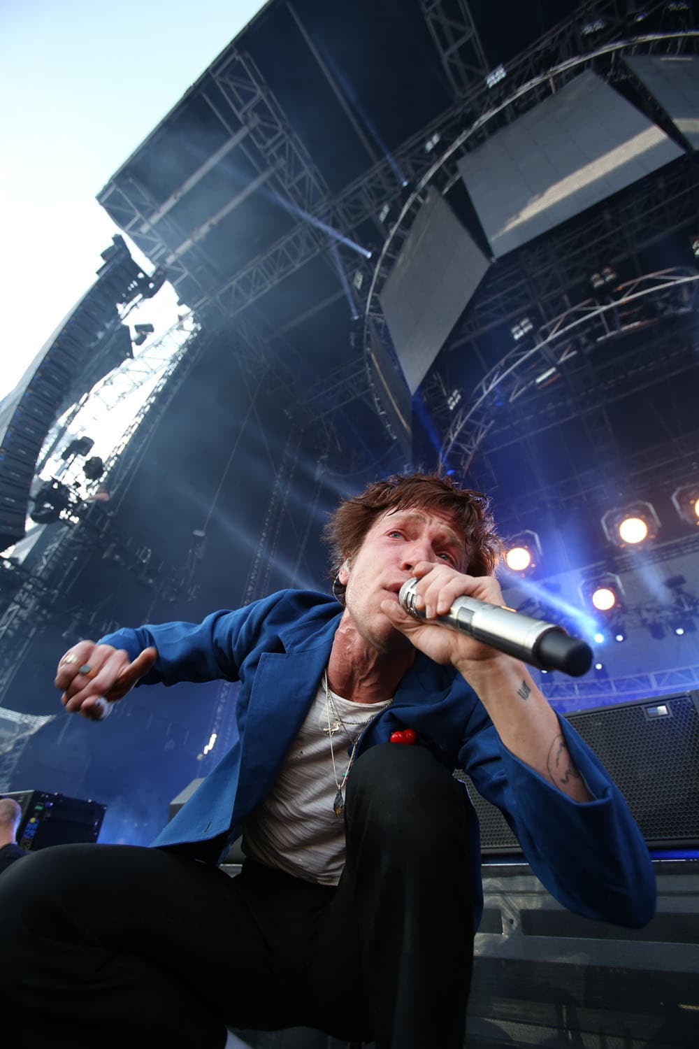 Professional concert photography of Matt Shultz performing with Cage the Elephant at major music festival. Indie rock festival performance captured with expert handling of stage lighting and dynamic motion.