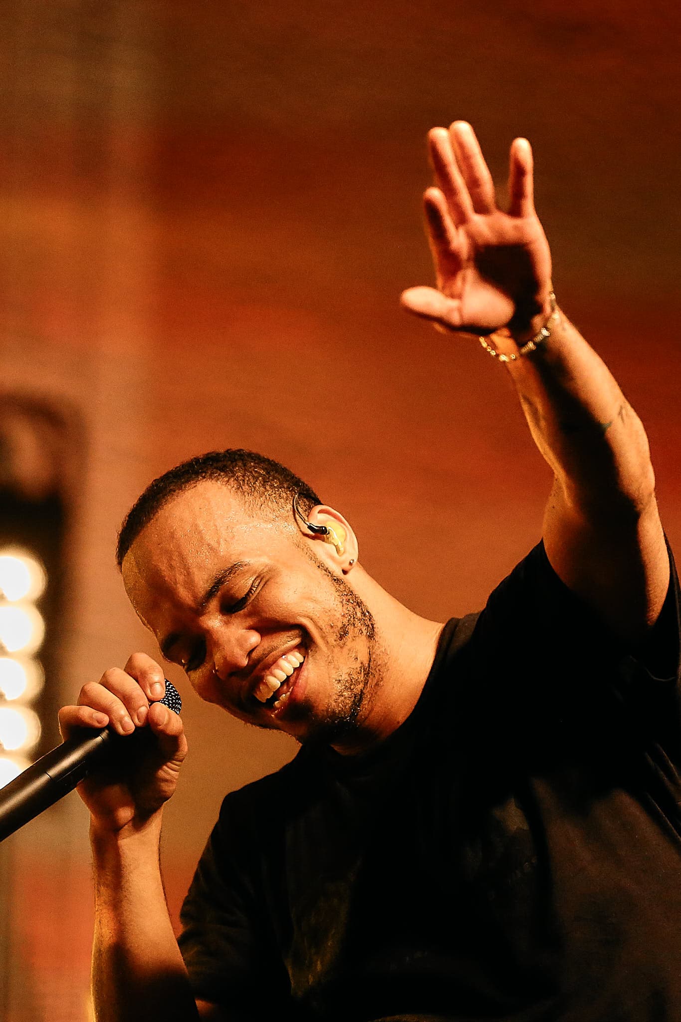 Concert photography of R&B and hip-hop artist Anderson .Paak performing at music festival. Professional music performance with dynamic stage presence and complex lighting conditions expertly captured.