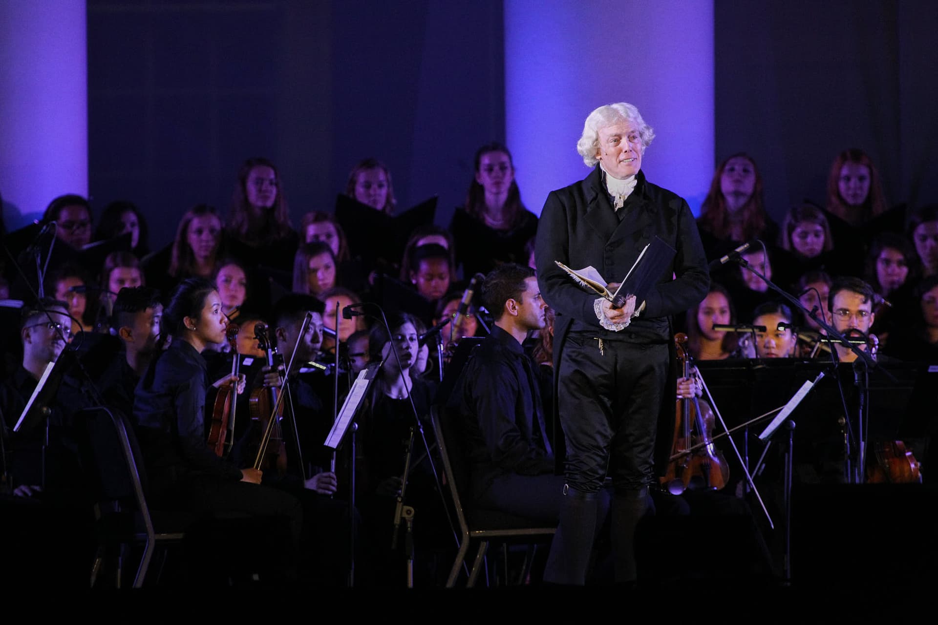 Classical music orchestra performance photography of the Virginia Bicentennial Orchestra. Large ensemble concert documentation with stage lighting and multiple musician coordination expertise.