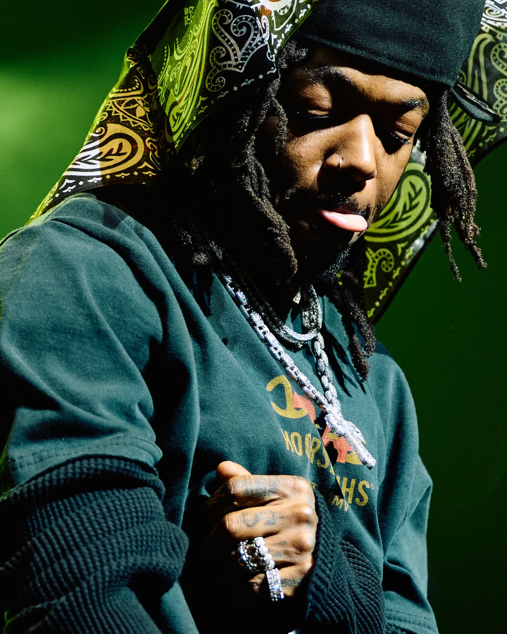Concert photography of singer-songwriter JID performing on stage. Professional music performance photography demonstrating skill capturing intimate artist moments and stage lighting dynamics.