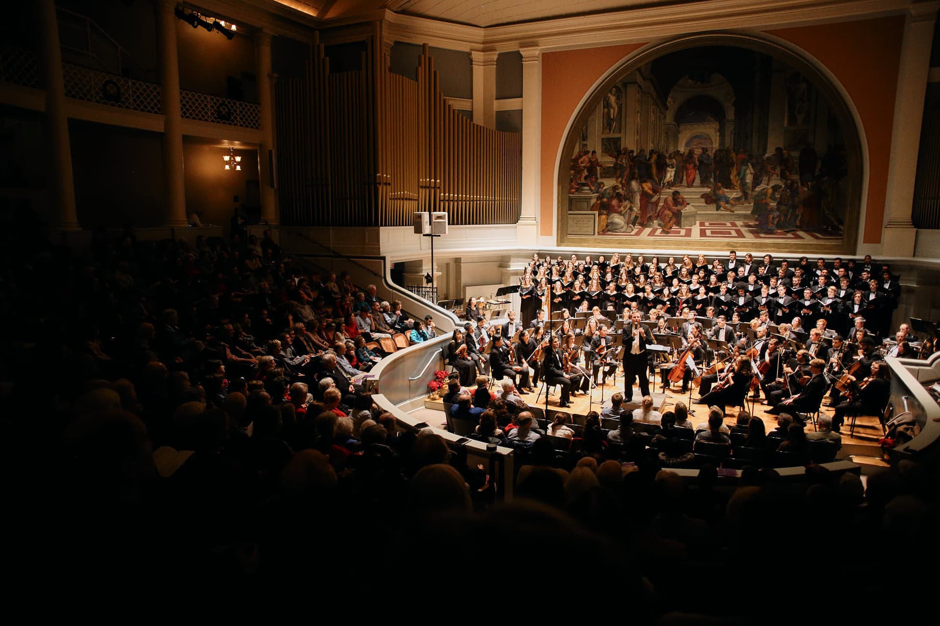 Classical music ensemble performance photography featuring Charlottesville Symphony Orchestra and University Singers. Large-scale chorus and orchestra concert with professional stage lighting and ensemble coordination capture.